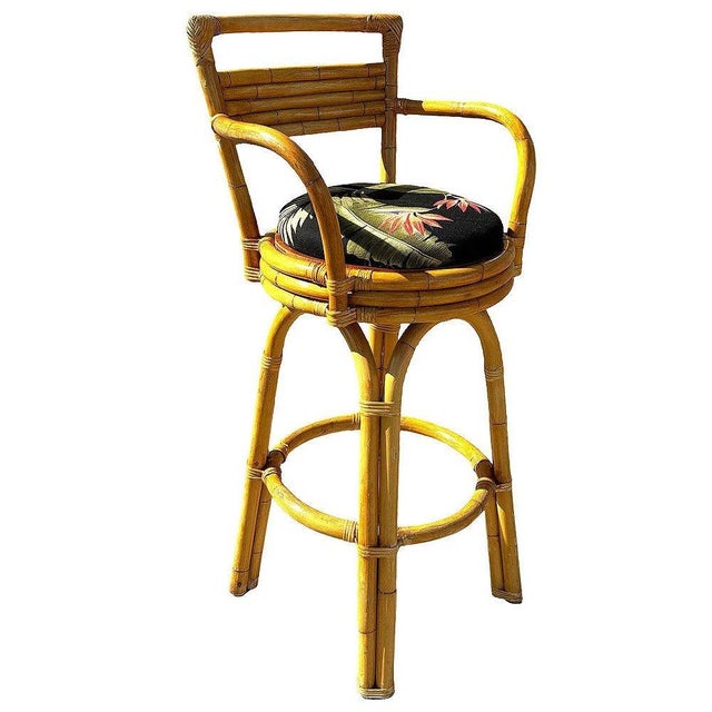 This set of three restored 1950s rattan bar stools combines Mid-century Modernist styling with the warmth of Hawaiian...