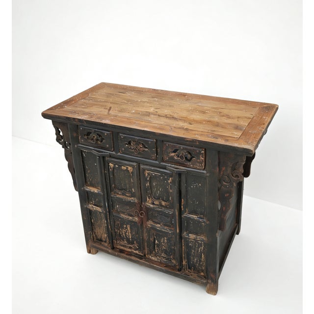 This 18th century antique elm coffer features a silhouette characterized by three upper drawers and a spacious two-door...