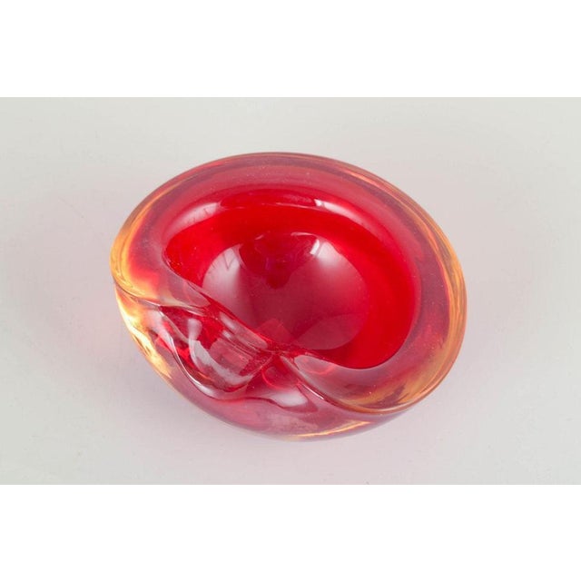 Murano art glass bowl, 1960s/70s. Organic freeform hand-blown bowl in deep ruby red sommerso glass with softly folded rim...