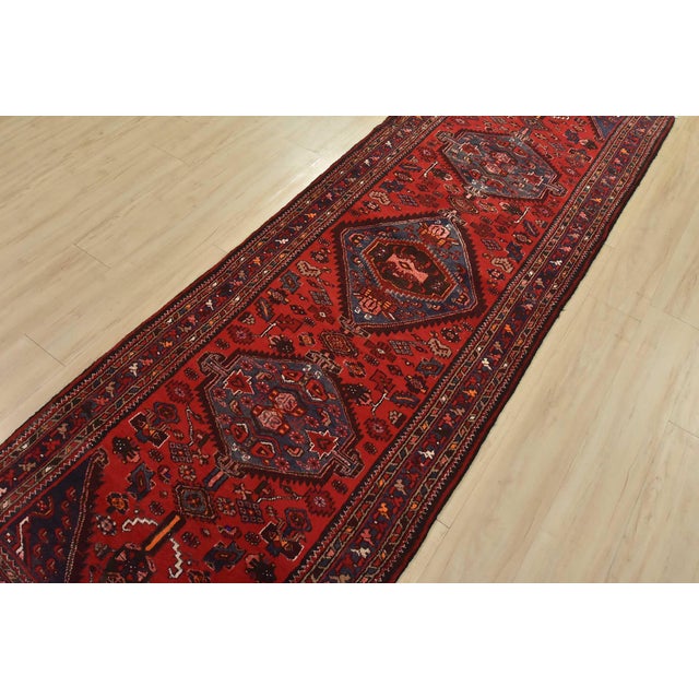 An authentic vintage tribal Zanjan runner hand-knotted with fine wool and natural dyes. This nomadic oriental rug features...
