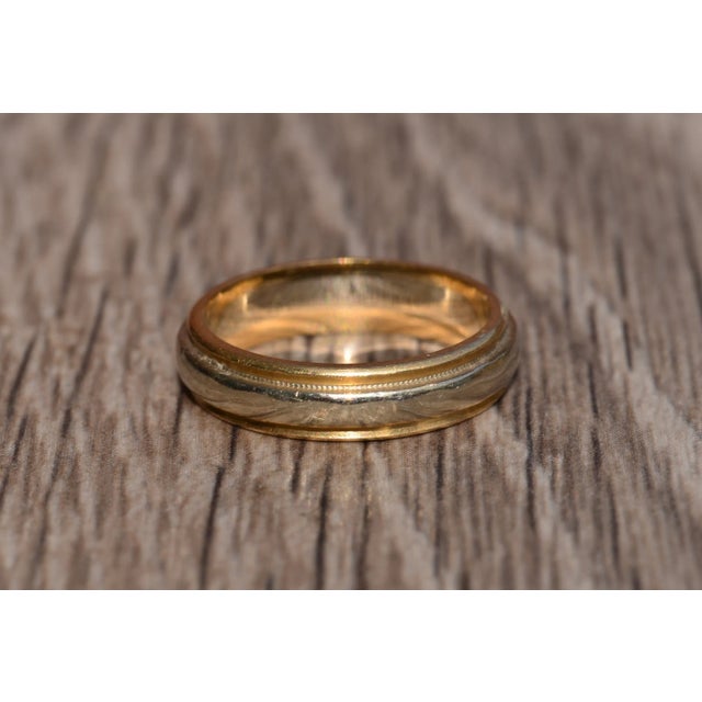 The Abbey Road Vintage Signed Two-Tone 14 Karat Wedding Band. This vintage band is crafted in 14 karat yellow and white...