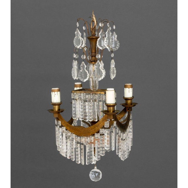 French Empire Style Brass and Crystal Chandelier, four arms with candlestick style light mounts, around square central...