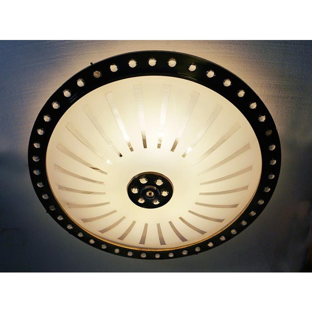 Unique oversized flying saucer flush mounted light with an extra large curved acrylic glass shade in a brass frame...