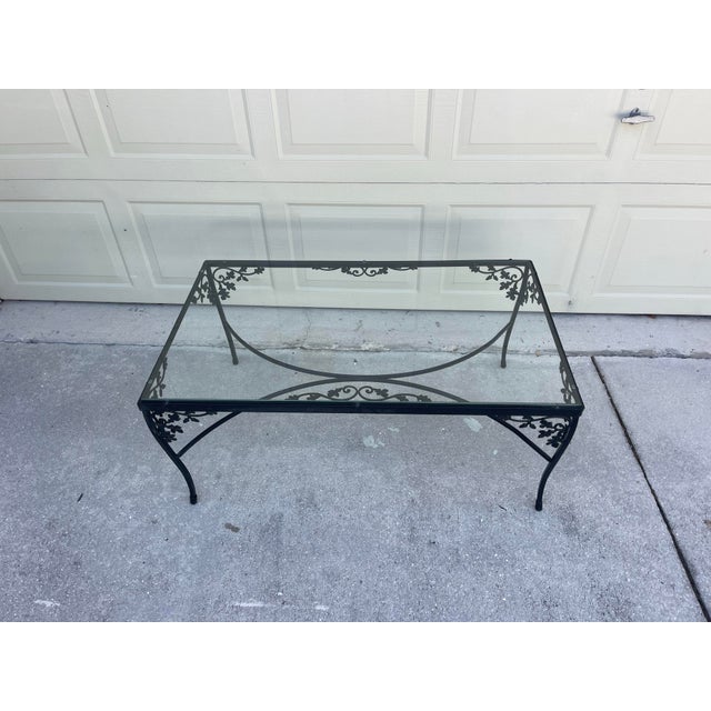 Vintage Woodard Orleans wrought iron coffee table and end table featuring delicate botanical scrollwork and glass tops....