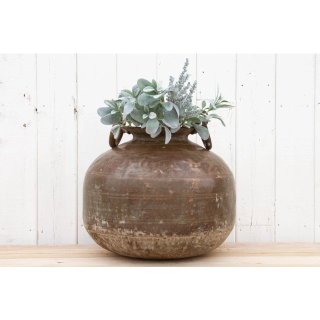 This gorgeous antique Indian brass planter with handles is a perfect addition to any space, combining a unique antique...