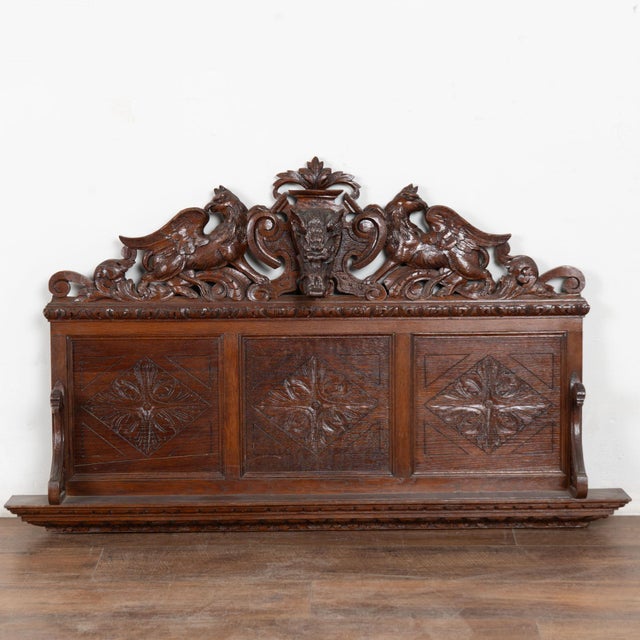 19th century carved wall shelf from Portugal, crafted in dark oak. Extensive hand carved decoration includes a central...