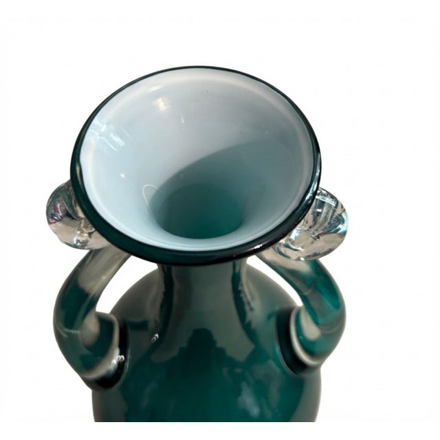 Striking vintage art glass vase in a rich jewel-toned teal green, accented with substantial clear applied glass handles....