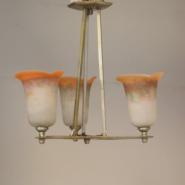 This pending light with a geometric motive in its fixture was produced by famous “Noverdy” company in France in the 1920s....