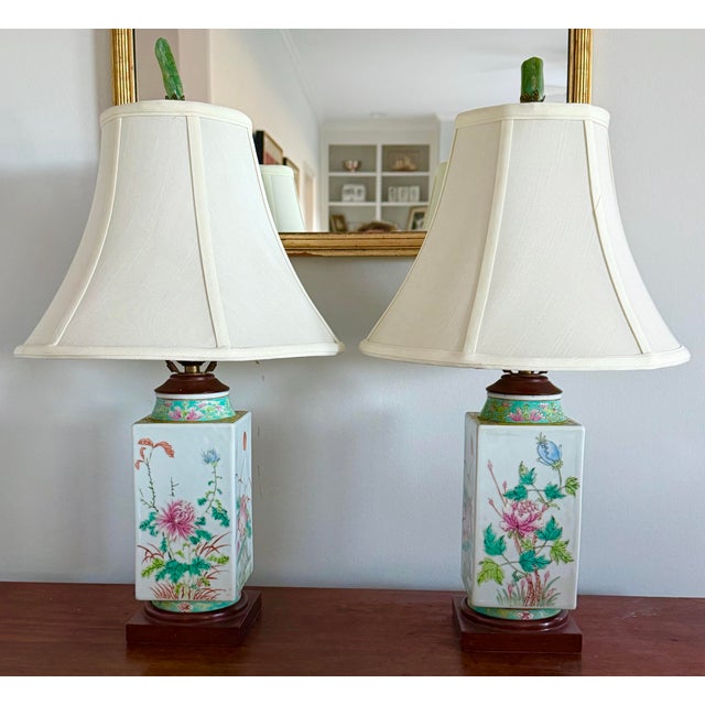 Pair of chinoiserie style table lamps. Pastel blues and pinks with yellow and blue green accents. Wonderful Jade finials....