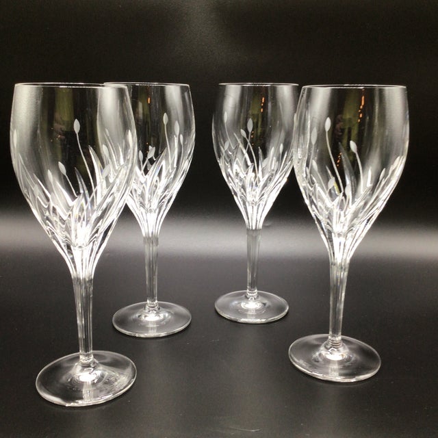 Set of 4 Noritake wine glasses with clear crystal bowl with cut plant or leaf-style designs and a distinctive ribbed stem....