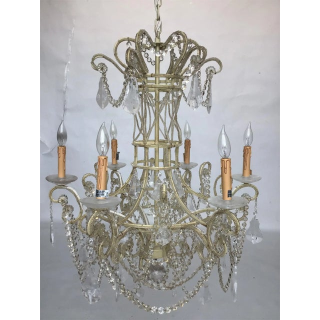 6-light chandelier in an ivory finish featuring a lattice style framework outlined in tiny beads with rows of cut crystal...