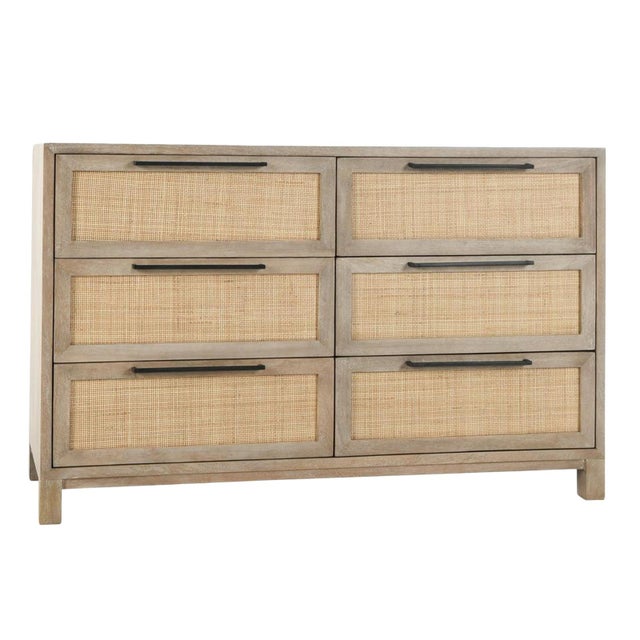 Coastal contemporary six-drawer dresser with mango wood frame and cane panel drawers. Black iron drawer pulls add...