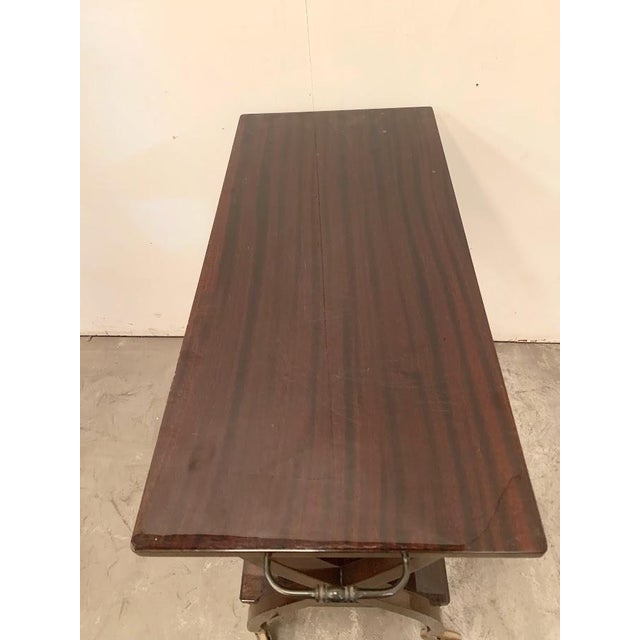 Serving table from the 1960s X-shaped base with casters Shelf between the legs Top with handles Good condition Dimensions:...