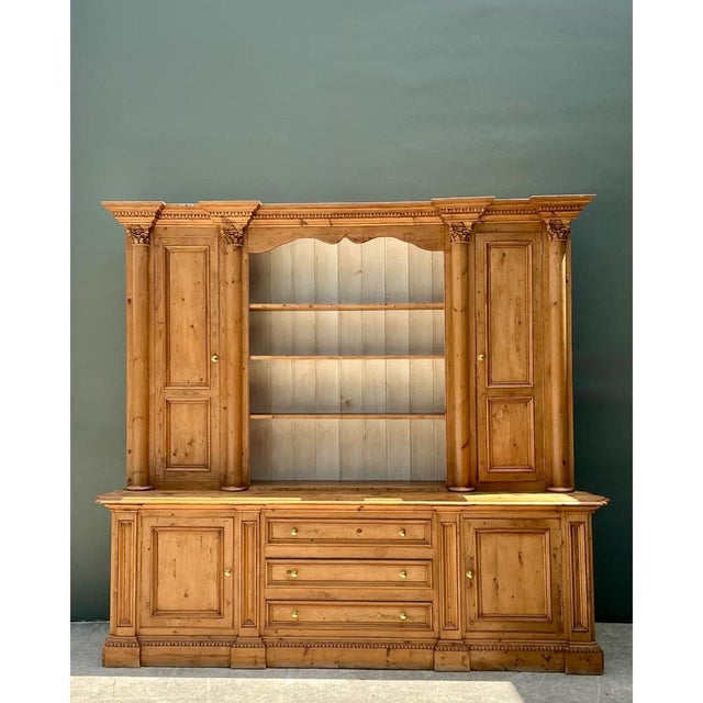 Exemplifying robust craftsmanship and timeless architectural presence, this vintage monumental rustic pine hutch is...