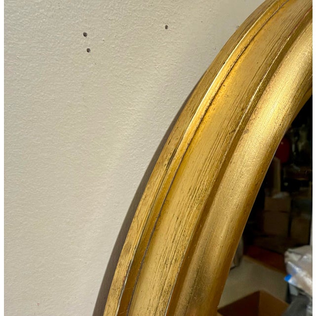 Italian gilt wood oval mirror with brass loop finial. Great size, Measures 27" high x 20" wide x 1.5" deep, (3" in height...