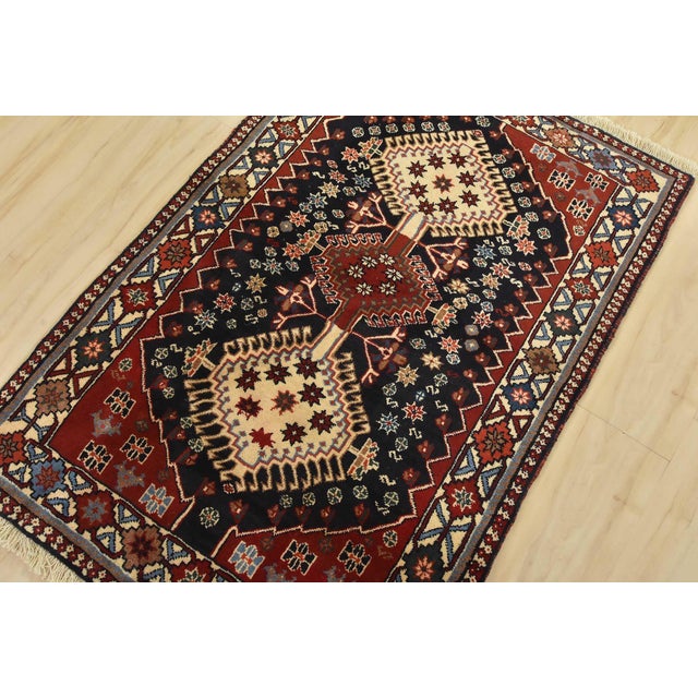 An authentic vintage tribal Yalameh rug hand-knotted with fine wool and natural dyes. This nomadic rug features geometric...