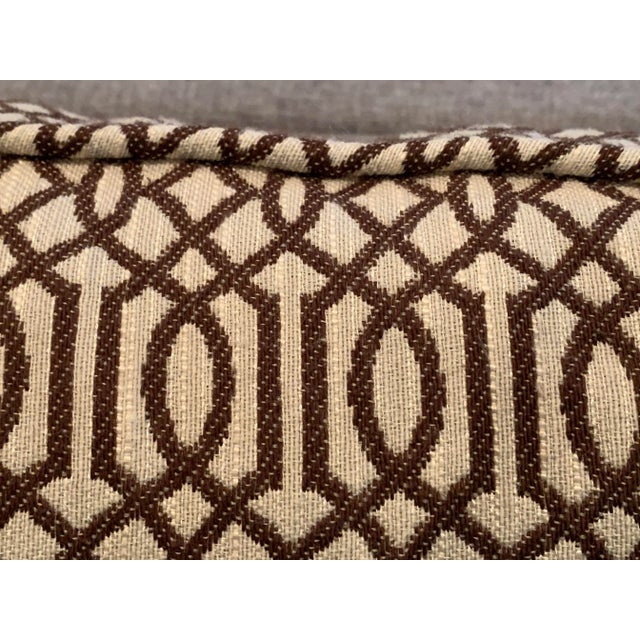 Pair of 20" square pillows with synthetic filling and zipper closure in abstract design of chocolate brown and cream fabric.