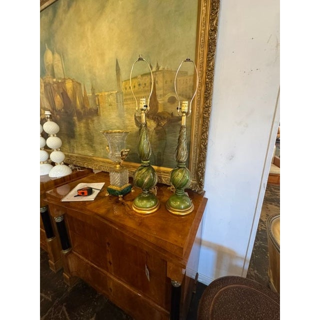 This pair of vintage Murano green glass lamps adds a touch of elegance and charm to any home decor. Featuring a twisted...