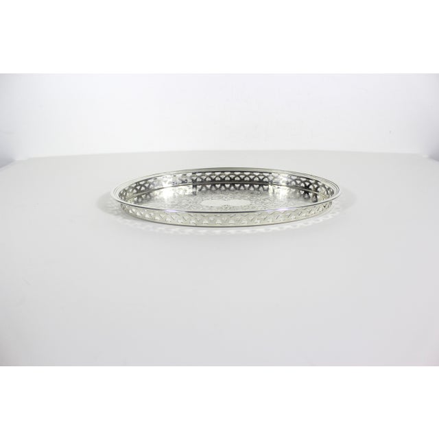 Vintage oval silver plated gallery tray with cutout detail on the raised edges and embossed detail inside. Recently...