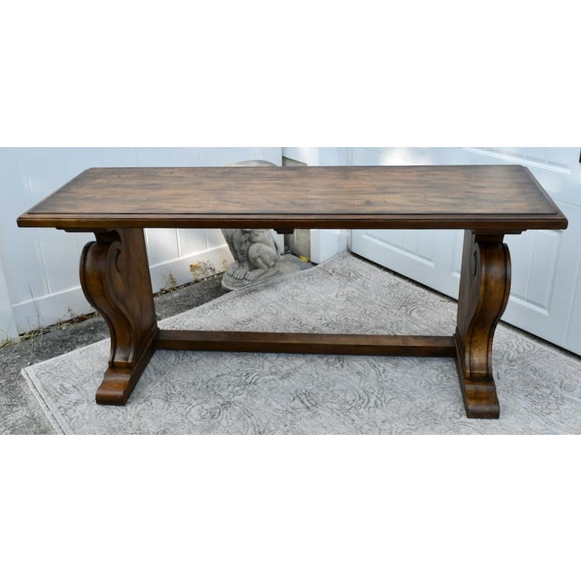 Vintage (1990's) Console Table has an Empire Style. Made by Ethan Allen. The Wood is Teak. Carved Wood with a Stretcher...