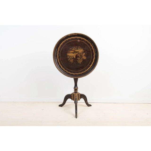 Late 18th century Swedish tray table. The table is decorated with wooden carvings. A fun detail is the painting on the...