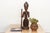 This seated figure depicts a Chokwe chief, or mwanangana — "lord of the land" — a title carrying both political authority...