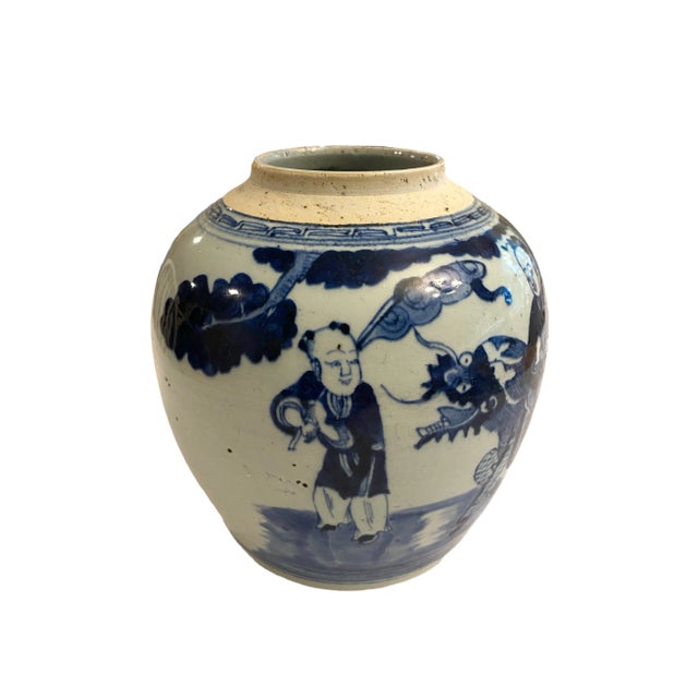 A charming hand-painted Chinese blue and white porcelain jar from the 19th century, featuring a trio of figures and a...