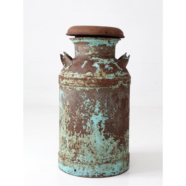 Antique milk can, circa 1920s–1940s, with a classic tall dairy form, two handles, and removable lid. Layers of beautifully...
