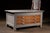 Heavy-duty wooden laboratory island or preparation table featuring a substantial painted frame fitted with six oversized...