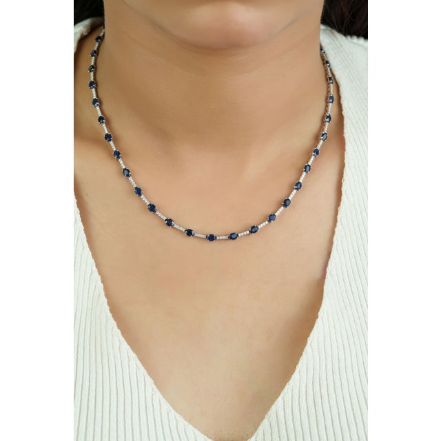 This tennis necklace showcases 10.52 carats of natural blue sapphires set in 14K White Gold. The sapphires accented by...