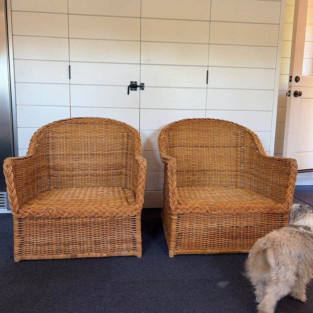 Pair of vintage woven rattan/wicker barrel-style accent chairs in very good condition. These chairs have a timeless...