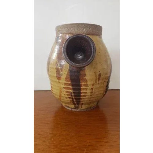 This Russell Collins Art Pottery Contemporary Stoneware Double Handled Vase, British measures 7 3/4" high and 9“ wide...