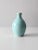 This is a vintage studio pottery vase. Signed by the artist, the hand-crafted bottleneck vase has a robin's egg blue glaze.