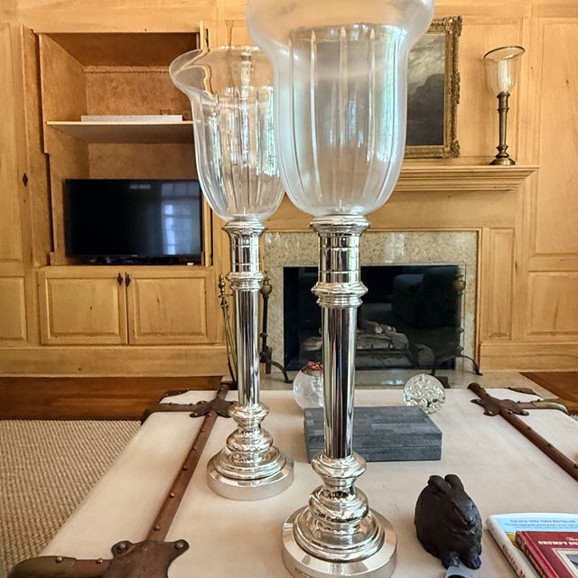 Pair of Silver Plated Ralph Lauren Hurricanes Fluted bell jar glass a top a silver candlestick. 27.75” x 9”