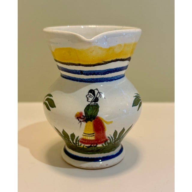 Cheerful small hand painted Quimper pitcher with bright colors and iconic Breton woman and flowers--brightens up any space...
