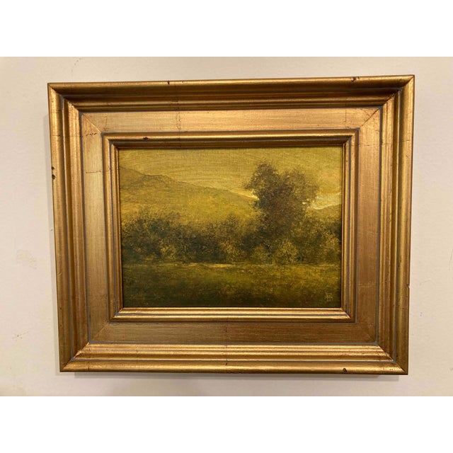This oil painting captures a serene landscape bathed in warm golden hues, evoking a sense of abundance and tranquility....