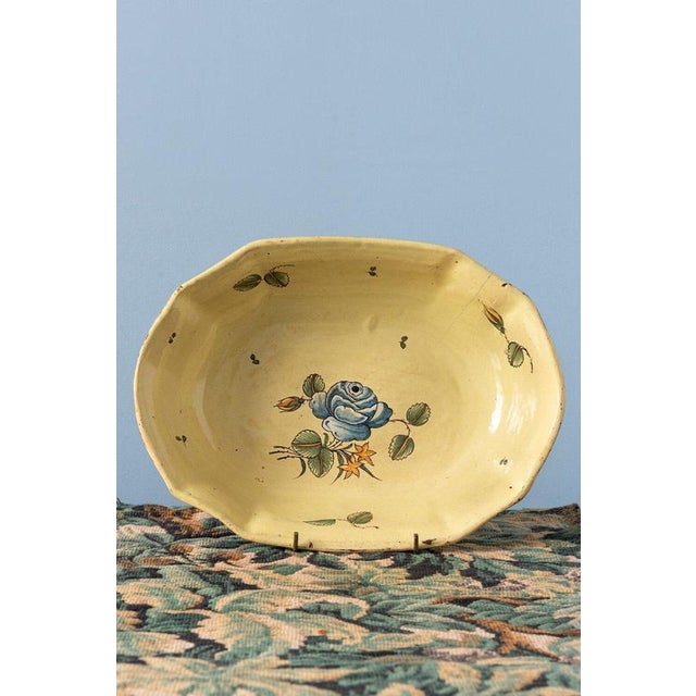 A pair of 18th-century French faience dishes from Moustiers, each with an elongated shallow form and delicately shaped...