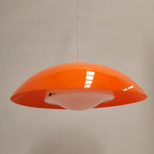 Mod 3013 Hanging Light in Orange from Guzzini, 1970s, in Very Good conditions. Designed 1970 to 1979 This piece has an...