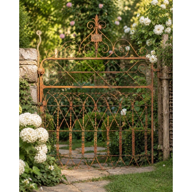 A wonderfully weathered antique ornamental iron garden gate with exceptional architectural character, believed to date to...
