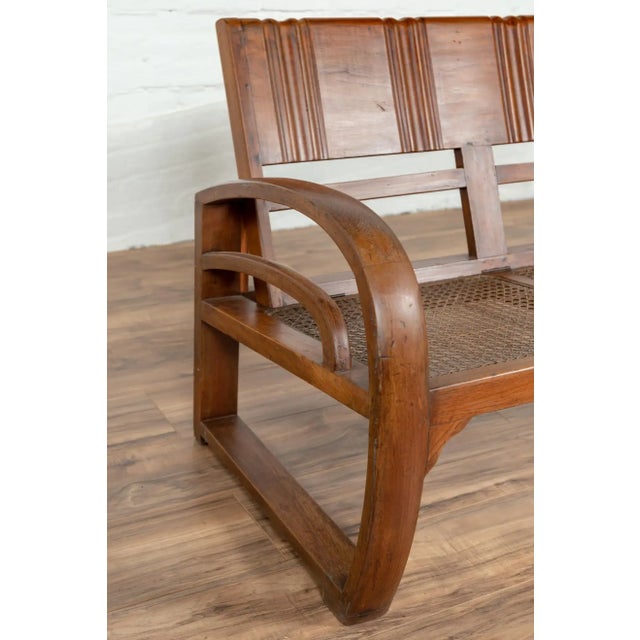 Teak Wood Settee from Madura with Folding Back, Looping Arms and Cane Seat For Sale - Image 11 of 13