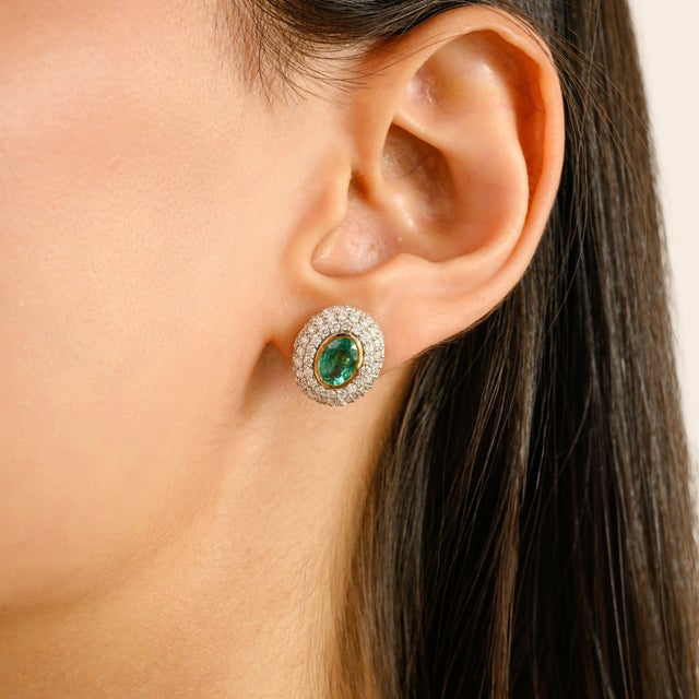 Radiating elegance and timeless charm, these exquisite earrings are crafted in 14k yellow gold and feature vibrant oval-...