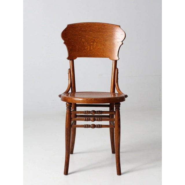 This is a classic wooden antique bentwood chair. Exhibiting sophisticated features with a round seat, triple turned...