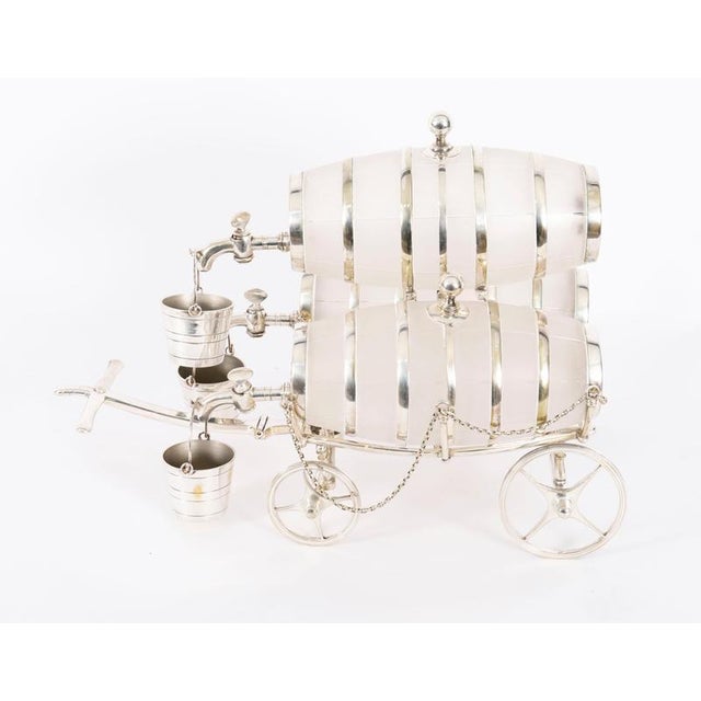 This is an elegant and rare antique Victorian silver plated three frosted crystal barrel dispenser decanter set, circa...