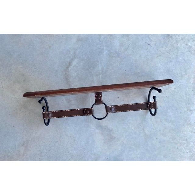 Hermès-style wall-mounted shelf with faux leather bracket made of painted metal. The shelf has been created in the style...