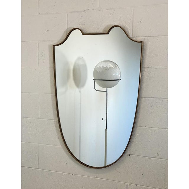1950s mirror in the style of Gio Ponti, brass border.