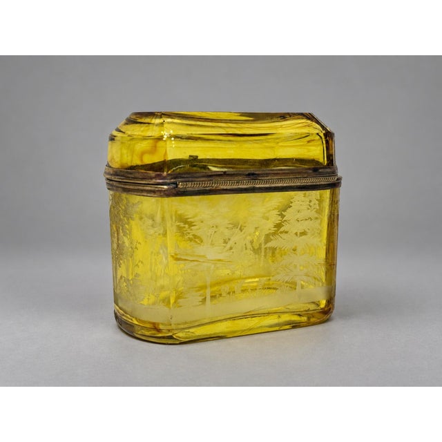 A fine late 19th-century Bohemian amber glass jewelry casket or table box, formed with a hinged domed lid, rounded...