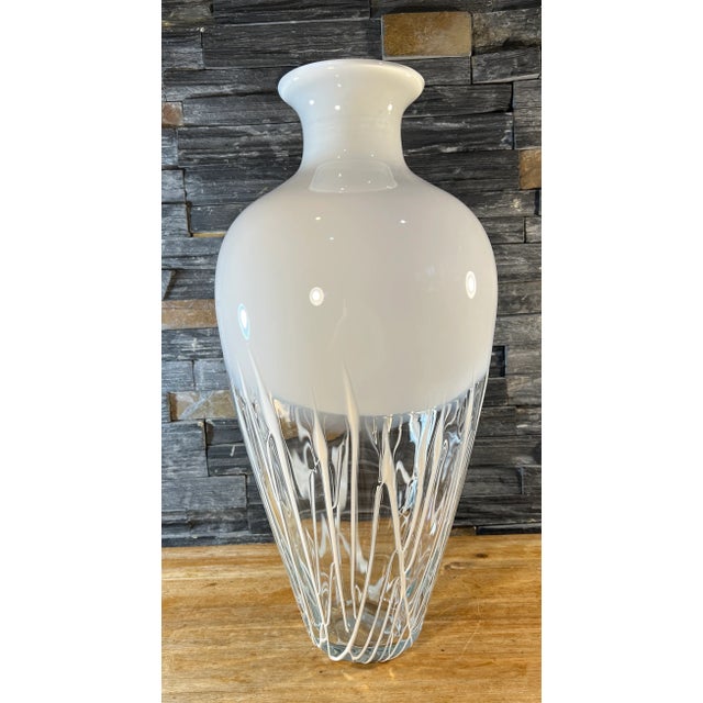 This 19-inch tall Art Glass Vase commands attention with its statuesque amphora-shaped profile. The vase's top half is a...