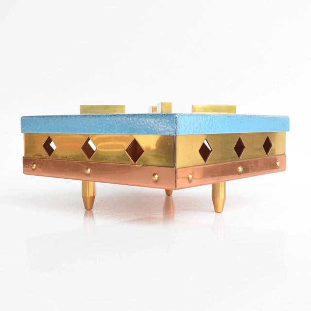 Hand-made tealight heater from the 1960s. German-made item in a mid-century modern style, made of brass and painted steel,...