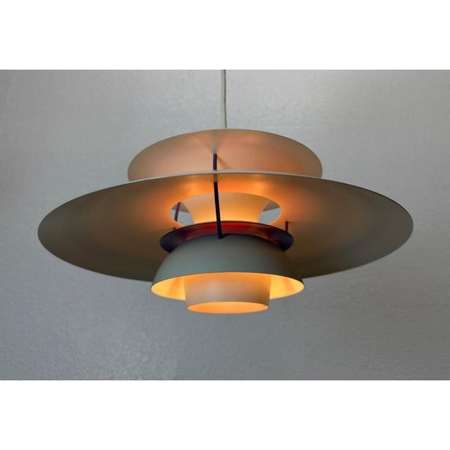 This iconic Danish 1960's cream ceiling pendant light was designed by Poul Henningsen for Louis Poulsen. This model is...