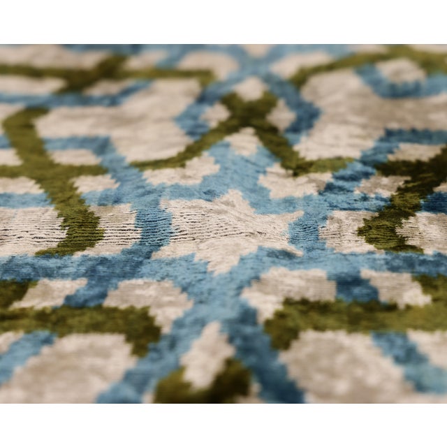 "Elevate your bespoke interior curation with the cool-toned sophistication of this hand-knotted silk velvet ikat pillow....